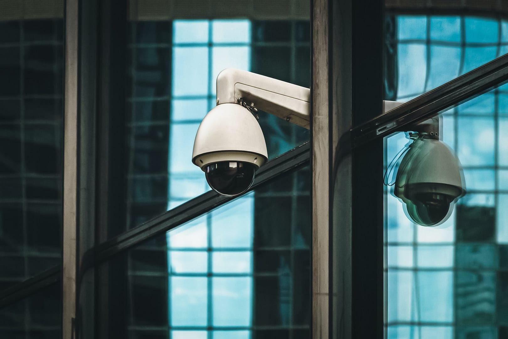 Security camera outdoors, surveillance 360 degree camera on modern building facade